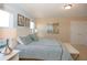 Bedroom featuring blue bedding with natural light and a bench seat at the foot of the bed at 4405 Acorn Ct, Davenport, FL 33837