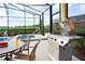 A stainless steel propane grill on a patio overlooking the lake with views of Florida landscape at 4405 Acorn Ct, Davenport, FL 33837