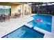 Screened in outdoor pool area with a heated spa, lounge chairs, and outdoor dining furniture at 4405 Acorn Ct, Davenport, FL 33837
