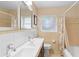 Bathroom featuring double sink vanity and shower/tub combo with neutral wall tile at 4700 Larado Pl, Orlando, FL 32812