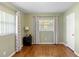 A spare room with hardwood floors and a window with patterned curtains at 4700 Larado Pl, Orlando, FL 32812
