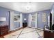 Comfortable primary bedroom with hardwood floors, decorative rug and blue painted walls at 4700 Larado Pl, Orlando, FL 32812