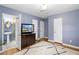 Comfortable primary bedroom with hardwood floors, decorative rug and blue painted walls at 4700 Larado Pl, Orlando, FL 32812