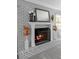 Cozy fireplace with gray painted brick surround and hearth with decorative mantle at 4700 Larado Pl, Orlando, FL 32812