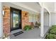 Inviting front porch with brick accents, a stylish front door, and potted plants at 4700 Larado Pl, Orlando, FL 32812