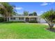 Charming single-story home with well-manicured lawn, tidy hedges, and a welcoming entrance at 4700 Larado Pl, Orlando, FL 32812