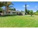 Charming single-story home with a brick entryway, manicured lawn, and lush landscaping, all under a clear blue sky at 4700 Larado Pl, Orlando, FL 32812