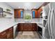 Bright kitchen with white countertops, wooden cabinets, stainless steel appliances and mosaic backsplash at 4700 Larado Pl, Orlando, FL 32812