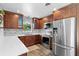 This stylish kitchen features quartz countertops and stainless steel appliances at 4700 Larado Pl, Orlando, FL 32812