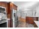 Well-equipped kitchen featuring stainless steel refrigerator, quartz counters, and a serving counter at 4700 Larado Pl, Orlando, FL 32812
