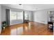 Comfortable living room with large window offering natural light and beautiful hardwood floors at 4700 Larado Pl, Orlando, FL 32812