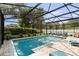 Beautiful screened-in pool area with stone pavers, lush landscaping, and outdoor seating at 4700 Larado Pl, Orlando, FL 32812