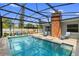 View of the screened-in pool with outdoor seating, grill, and well-maintained stone pavers at 4700 Larado Pl, Orlando, FL 32812