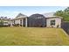 Spacious backyard with lush lawn and screened-in patio, creating an ideal outdoor oasis at 508 Yellow Submarine Ct, Groveland, FL 34736