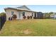 Well-maintained lawn and backyard featuring a screened patio and mature landscaping at 508 Yellow Submarine Ct, Groveland, FL 34736
