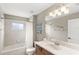 Bathroom features a shower/tub combo, vanity and a decorative mirror at 508 Yellow Submarine Ct, Groveland, FL 34736