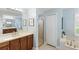 Bathroom featuring a soaking tub, vanity with wood cabinets and a glass-enclosed shower at 508 Yellow Submarine Ct, Groveland, FL 34736