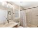 Bathroom featuring a shower/tub combo, vanity, decorative mirror and a window at 508 Yellow Submarine Ct, Groveland, FL 34736