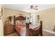 Comfortable bedroom with hardwood floors, decorative wood trim and a ceiling fan at 508 Yellow Submarine Ct, Groveland, FL 34736