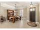 Open dining room features a farmhouse table, wooden hutch, large window and decorative lighting at 508 Yellow Submarine Ct, Groveland, FL 34736