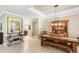 Open dining room with view of the kitchen, farmhouse table, wooden hutch, and decorative lighting at 508 Yellow Submarine Ct, Groveland, FL 34736