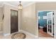 Inviting foyer with a decorative rug, a chandelier and views of an office through glass doors at 508 Yellow Submarine Ct, Groveland, FL 34736