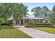Charming single-story home with metal roof, stone accents, inviting porch and well manicured landscaping at 508 Yellow Submarine Ct, Groveland, FL 34736