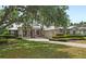 Charming single-story home with metal roof, stone accents, inviting porch and well manicured landscaping at 508 Yellow Submarine Ct, Groveland, FL 34736