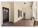 Inviting covered front porch with stone columns, brick pavers, and dark wood front door at 508 Yellow Submarine Ct, Groveland, FL 34736