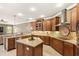 Bright kitchen boasts stainless appliances, granite counters, custom cabinets, and center island at 508 Yellow Submarine Ct, Groveland, FL 34736
