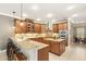 Spacious kitchen with wood cabinets, granite countertops, stainless steel appliances, and center island at 508 Yellow Submarine Ct, Groveland, FL 34736