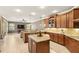 Open kitchen with granite countertops, stainless appliances, a center island, and seamless living space at 508 Yellow Submarine Ct, Groveland, FL 34736