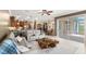 Open-concept living room with views of the kitchen, dining area, and lanai, with comfortable seating at 508 Yellow Submarine Ct, Groveland, FL 34736