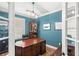 Stylish office features a large desk, leather chair, wooden floors, and modern lighting at 508 Yellow Submarine Ct, Groveland, FL 34736