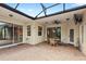 Enjoy outdoor living on this screened patio with brick flooring and comfortable seating area at 508 Yellow Submarine Ct, Groveland, FL 34736