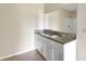 Bathroom featuring a granite countertop with double sinks and white cabinets at 536 Talisi Loop, St Cloud, FL 34771