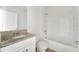Clean bathroom with a granite vanity, white cabinetry and a tub/shower combo at 536 Talisi Loop, St Cloud, FL 34771