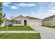 Charming single-story home with a well-manicured lawn and attached two-car garage at 536 Talisi Loop, St Cloud, FL 34771