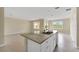 Open-concept kitchen with a center island, granite countertops and modern appliances at 536 Talisi Loop, St Cloud, FL 34771