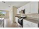 Well-equipped kitchen featuring granite counters, stainless steel appliances, and white cabinetry at 536 Talisi Loop, St Cloud, FL 34771