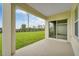 Covered patio featuring sliding doors and expansive backyard views and blue skies at 536 Talisi Loop, St Cloud, FL 34771