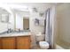 Well-lit bathroom with a granite vanity, fresh towels, and a shower-tub combination for convenience at 626 Verona Ave, Davenport, FL 33897