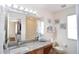 Bright bathroom featuring a granite countertop, a well-lit mirror, and a combined shower and tub at 626 Verona Ave, Davenport, FL 33897
