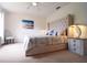 Serene bedroom featuring a tufted headboard, soft neutral tones, and ample natural light for a relaxing retreat at 626 Verona Ave, Davenport, FL 33897