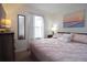 Inviting bedroom featuring a soft pink comforter, a large window, and a calming ambiance at 626 Verona Ave, Davenport, FL 33897