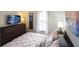 Comfortable bedroom with a wooden dresser and calming wall art makes the space inviting and cozy at 626 Verona Ave, Davenport, FL 33897