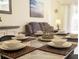 Cozy dining area with a marble table and seating for six, creating a perfect spot for intimate meals at 626 Verona Ave, Davenport, FL 33897