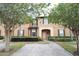 Inviting two-story townhome featuring a brick pathway and mature landscaping, creating curb appeal at 626 Verona Ave, Davenport, FL 33897