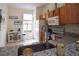 Well-lit kitchen with granite countertops, wooden cabinetry, and stainless steel faucet at 626 Verona Ave, Davenport, FL 33897