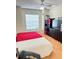 Well-lit bedroom with vinyl floors, a ceiling fan, a big window and neutral decor at 6518 Garden Spring Ct, Orlando, FL 32818